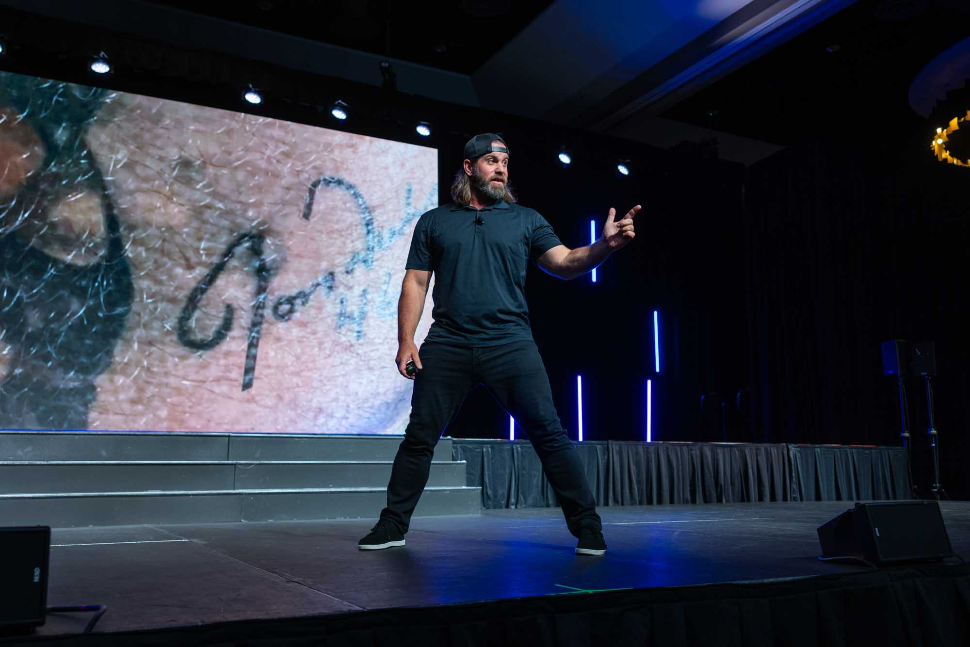 Man on stage pointing out toward the crowd
