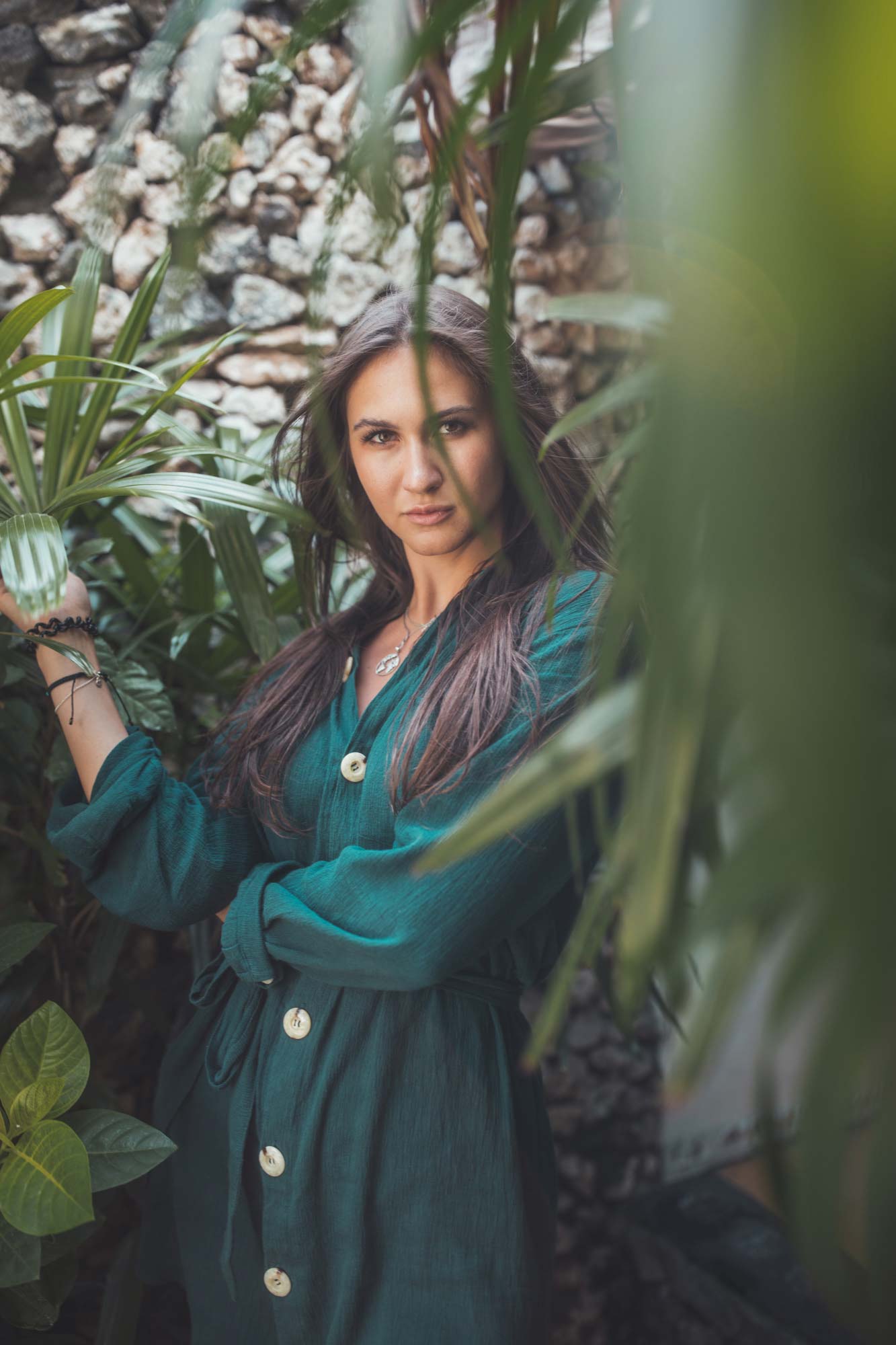 Lifestyle portrait photography of a woman in a lush garden setting in Bali.