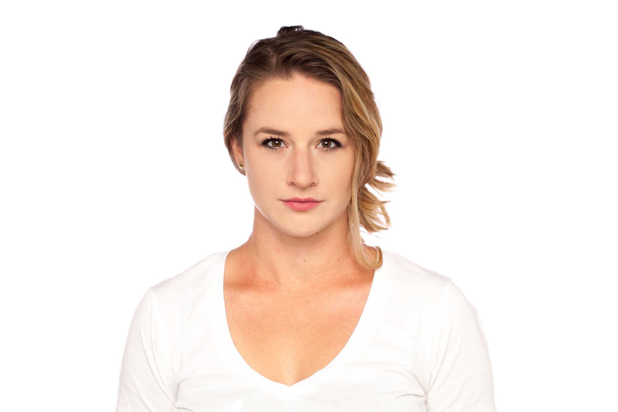 Studio headshot of Allison Rehnberg on a white background — dirty-blonde hair pulled back, white V-neck tee, neutral expression.