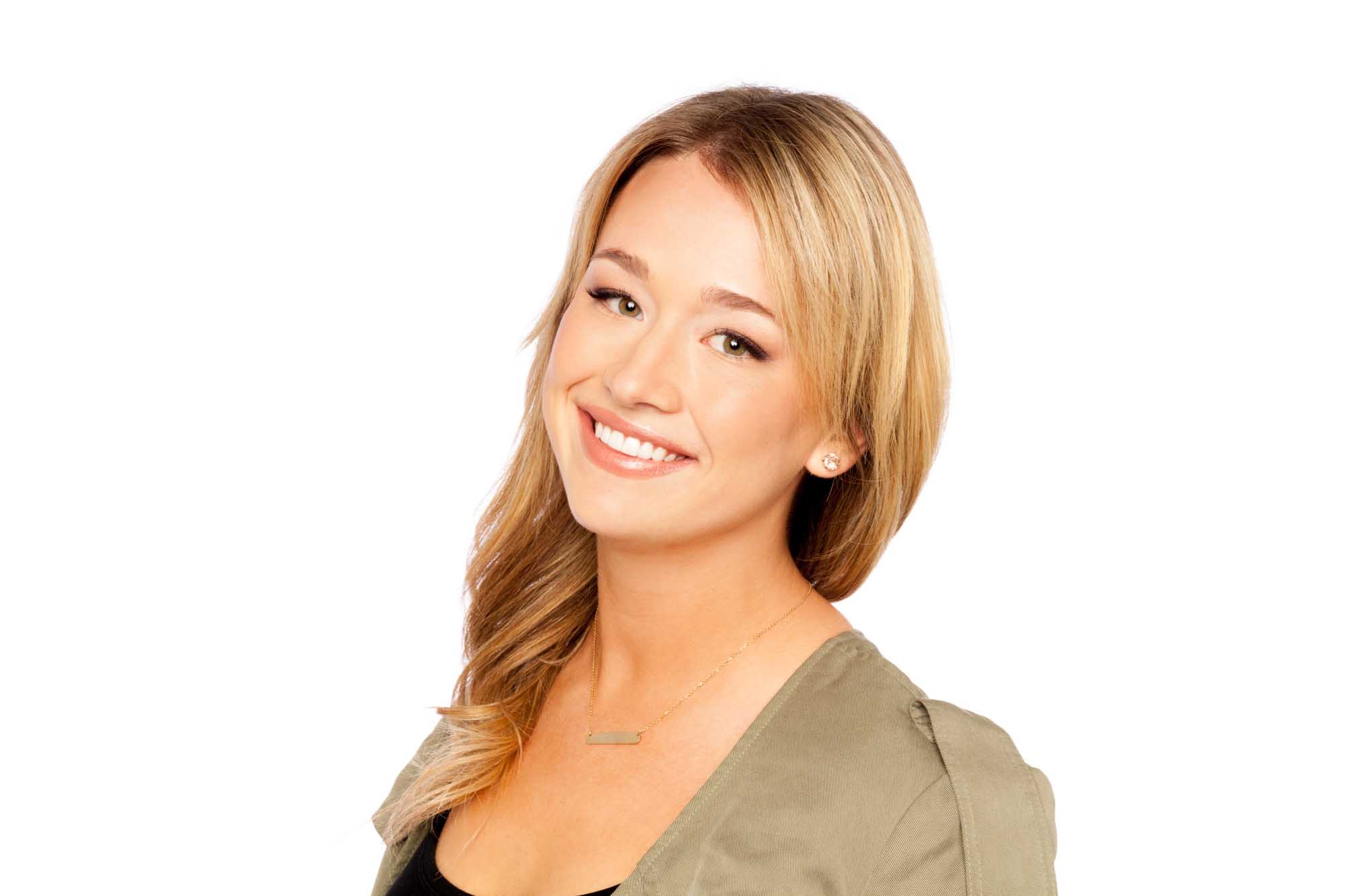 Studio headshot of Madison Morris on a white background — layered blonde hair, warm smile, olive blazer over a black top with a gold bar necklace.